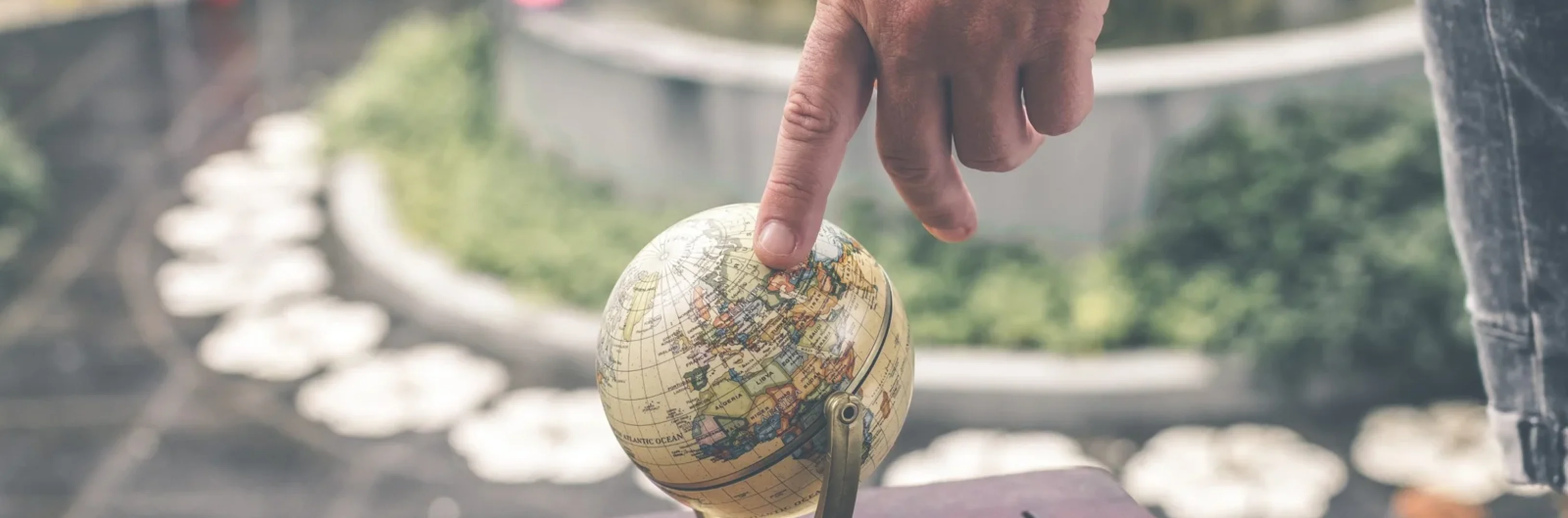 person-holding-terrestrial-globe-scale-model-taken-1079033-scaled-1